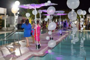 Photo of product launch guests enjoying the balloons in the pool for a Blue Spark Event Design - Product Launch Miami