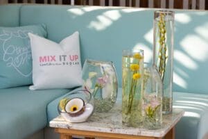Photo of custom pillow, sunken floral, salt and coconut design, tall vase, circle vase, etc. for a Blue Spark Event Design - Product Launch Miami