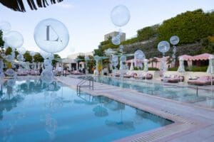Photo of custom balloons floating in a pool for a Blue Spark Event Design - Product Launch Miami